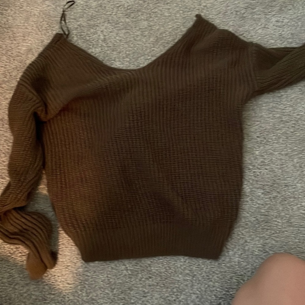 This is a brown sweater it’s soft and has a opened back with a knot